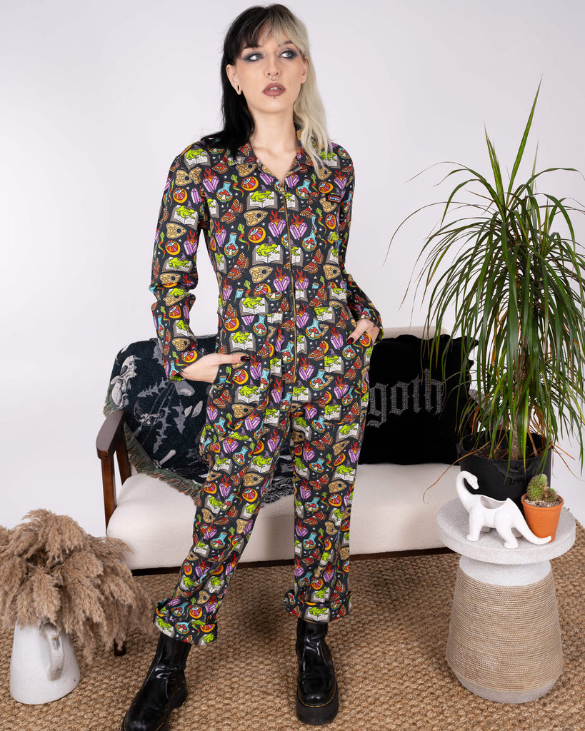 Front-facing view of the Halloween: Bewitched Boiler Suit by Run & Fly. The model showcases the fun print with frogs, skulls, and potions, a perfect blend of spooky and ethical slow fashion.