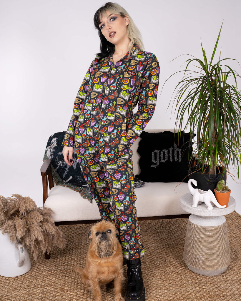 Model posing in Run & Fly’s Halloween: Bewitched Boiler Suit with a small dog. The whimsical print and ethical craftsmanship make this piece a standout for quirky slow fashion enthusiasts.