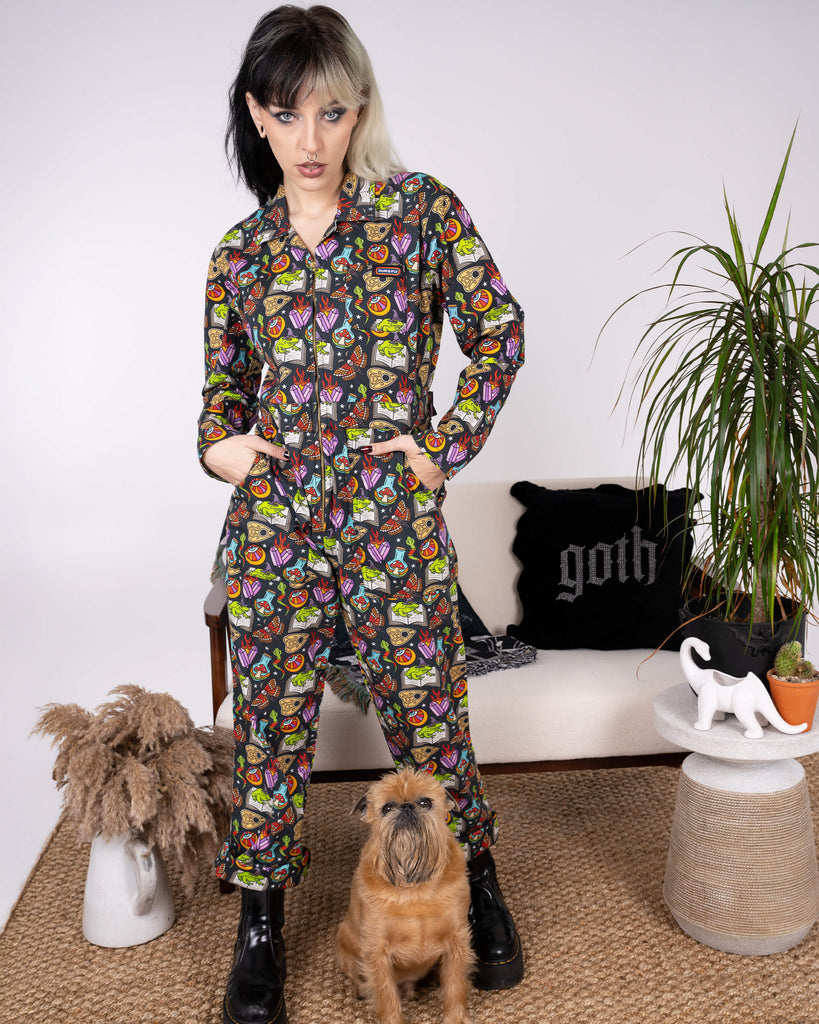 Full view of the Halloween: Bewitched Boiler Suit by Run & Fly, worn by a model. The vibrant print features magical motifs like frogs, potions, and moths, celebrating slow fashion with a spooky twist.