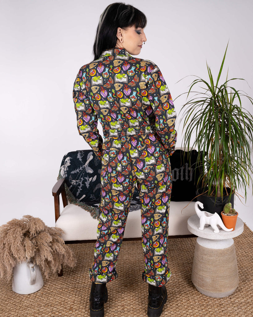 Model standing away from camera in Run & Fly’s Halloween: Bewitched Boiler Suit. The playful spooky print features frogs, flames, and crystal balls, making it a standout piece in ethical slow fashion.