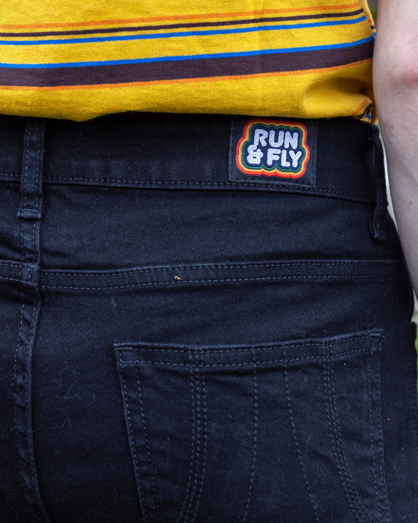 close up of the run & fly logo on the back of the jeans worn by Jack 