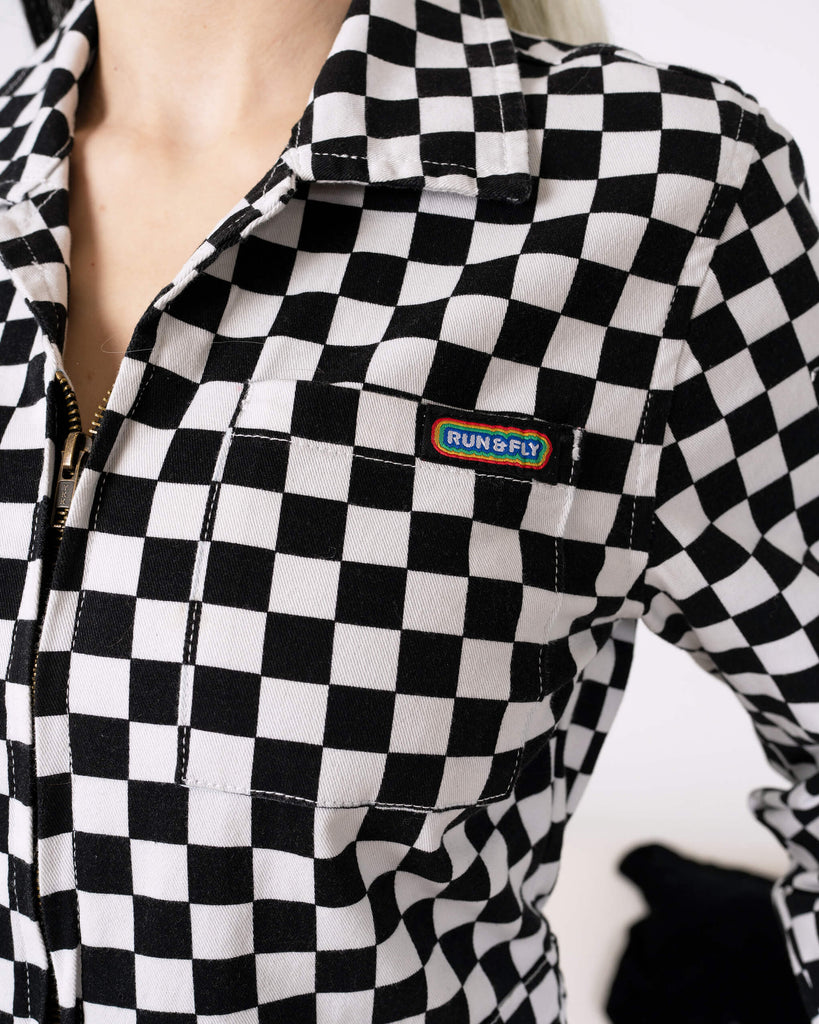 The Run & Fly logo patch is featured on the chest pocket of the Black & White Checkerboard Stretch Twill Boiler Suit. Durable and unique, the ethical slow fashion design adds personality to your wardrobe.