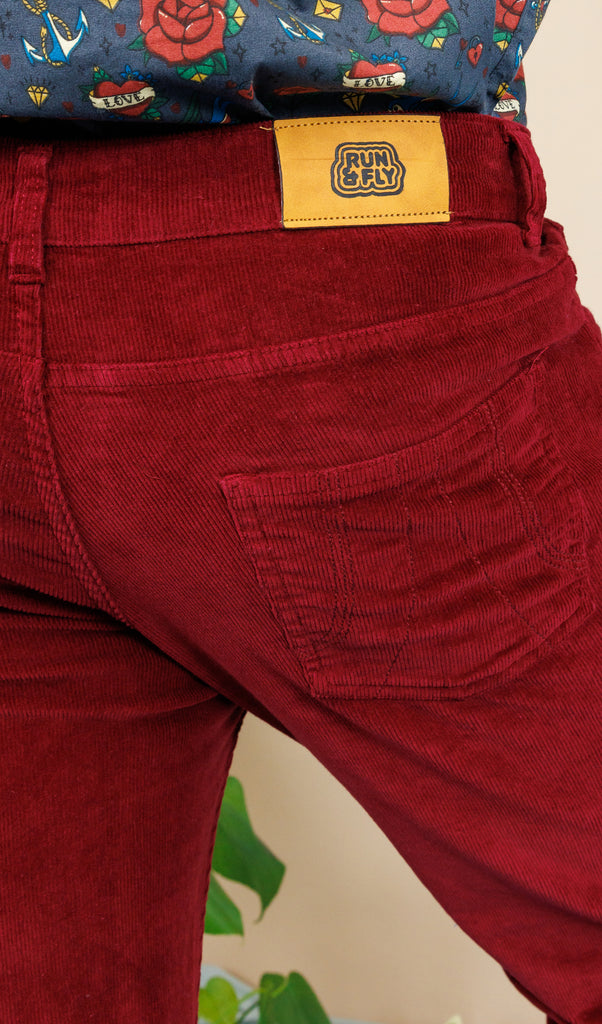 close p of the back of the Tawney Port Corduroy Bell Bottom Flares with the Run & Fly logo label on the back.