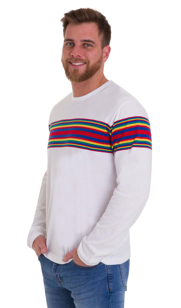  Male model smiling, standing against a white background, wearing the Retro Rainbow Engineered Striped Long Sleeve T Shirt with blue jeans