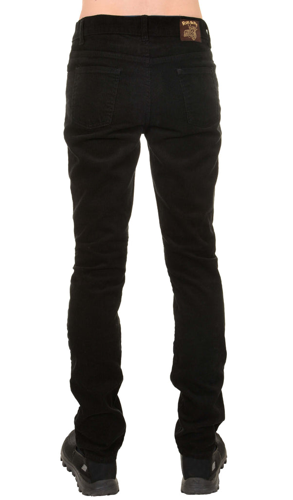 Model is stood in front of a white studio background wearing the mens 60s black corduroy slim fit jeans with black trainers. They are facing away from the camera to highlight the back and run and fly waist label details. Photo is cropped from the waist down.