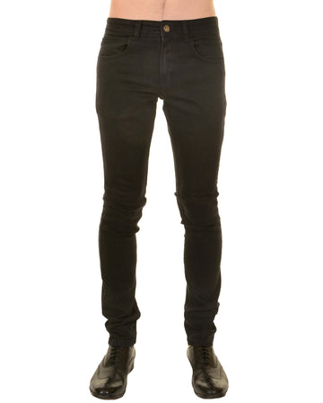 Model is stood in front of a white studio background wearing the mens 60s black corduroy slim fit jeans with black trainers. They are facing towards the camera. Photo is cropped from the waist down.