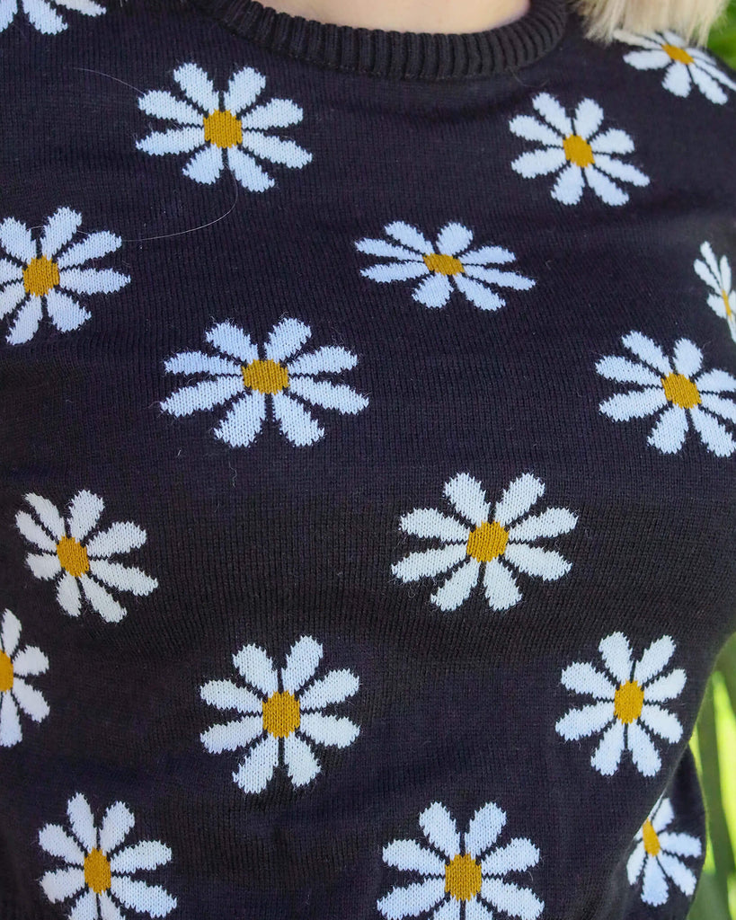 Close up of Florence wearing nude brown lipstick and the Daisy Chain Black Cropped Jumper