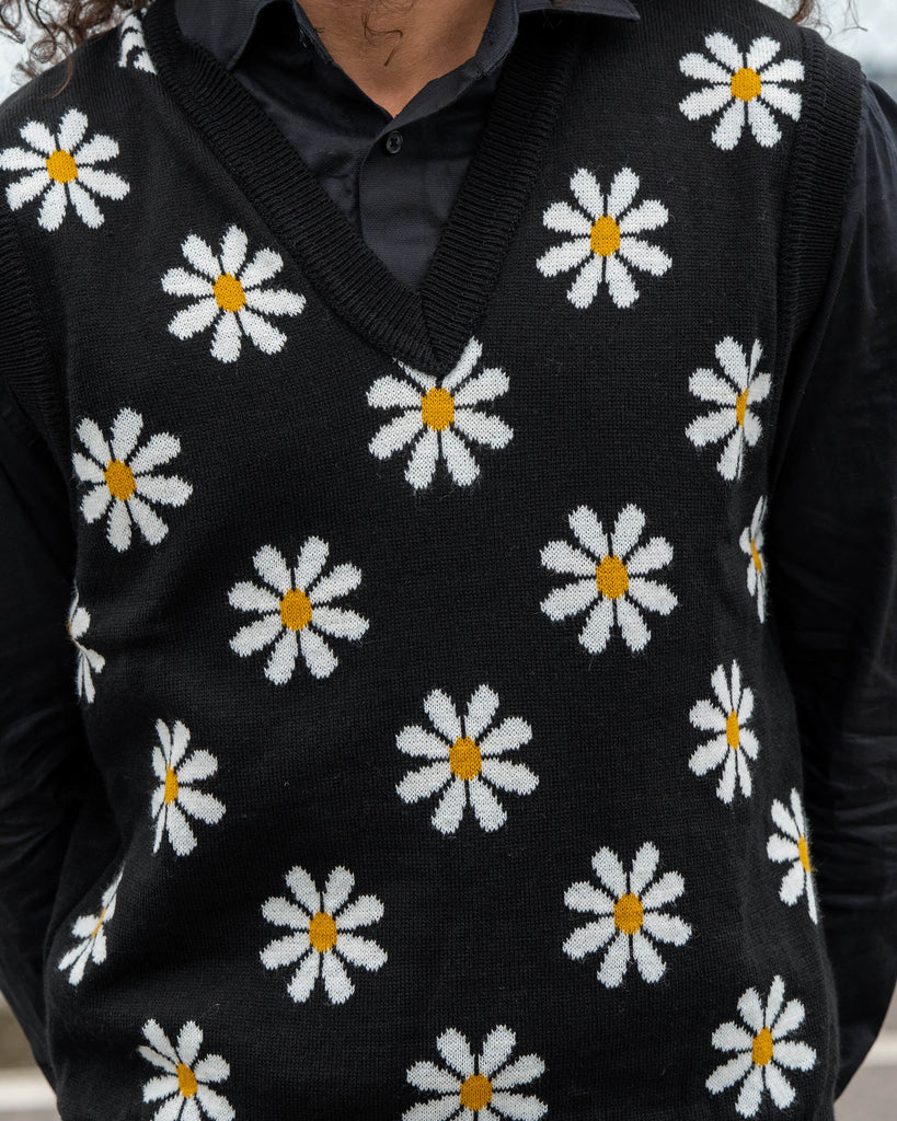 Close-up of the Run & Fly Black Daisy Tank Vest showing detailed white daisy flowers with yellow centres knitted on black fabric.