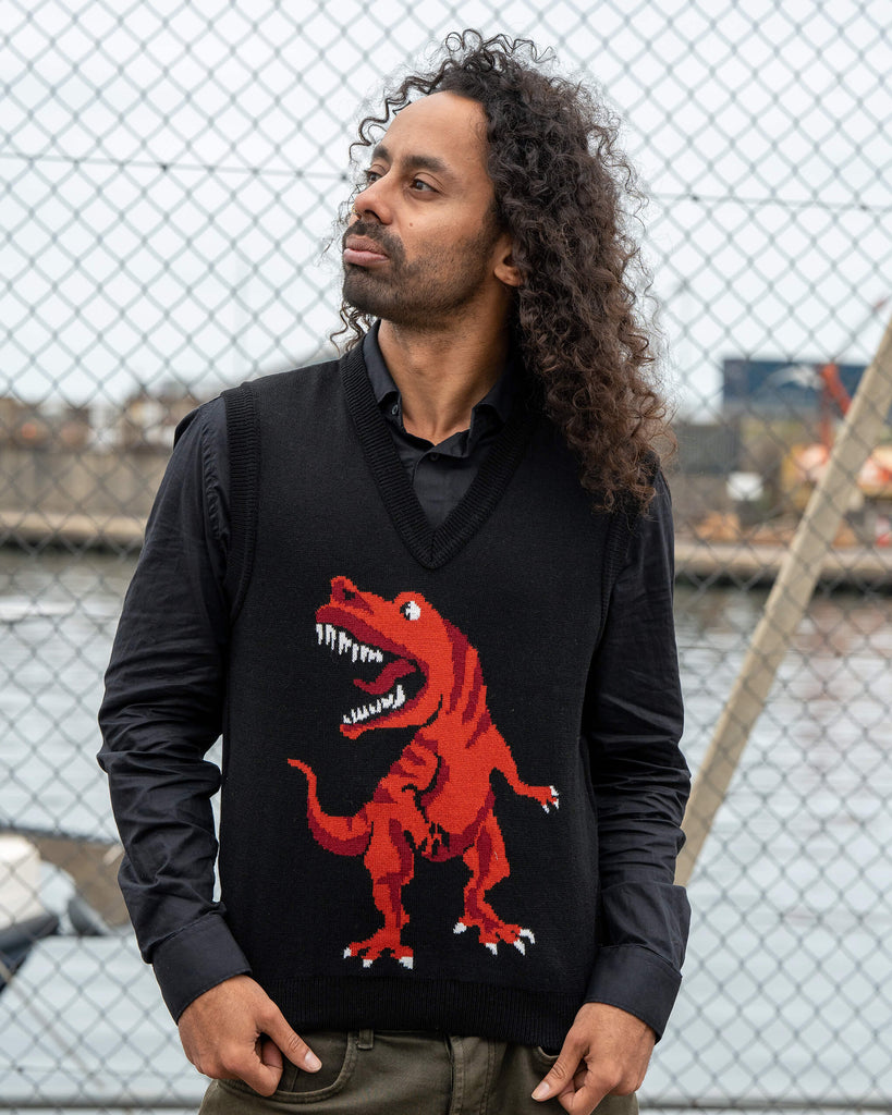 Front view of the unisex Run & Fly Red Dino Tank Vest with a large red T-Rex graphic on black. Model Rich wears it over a black shirt.