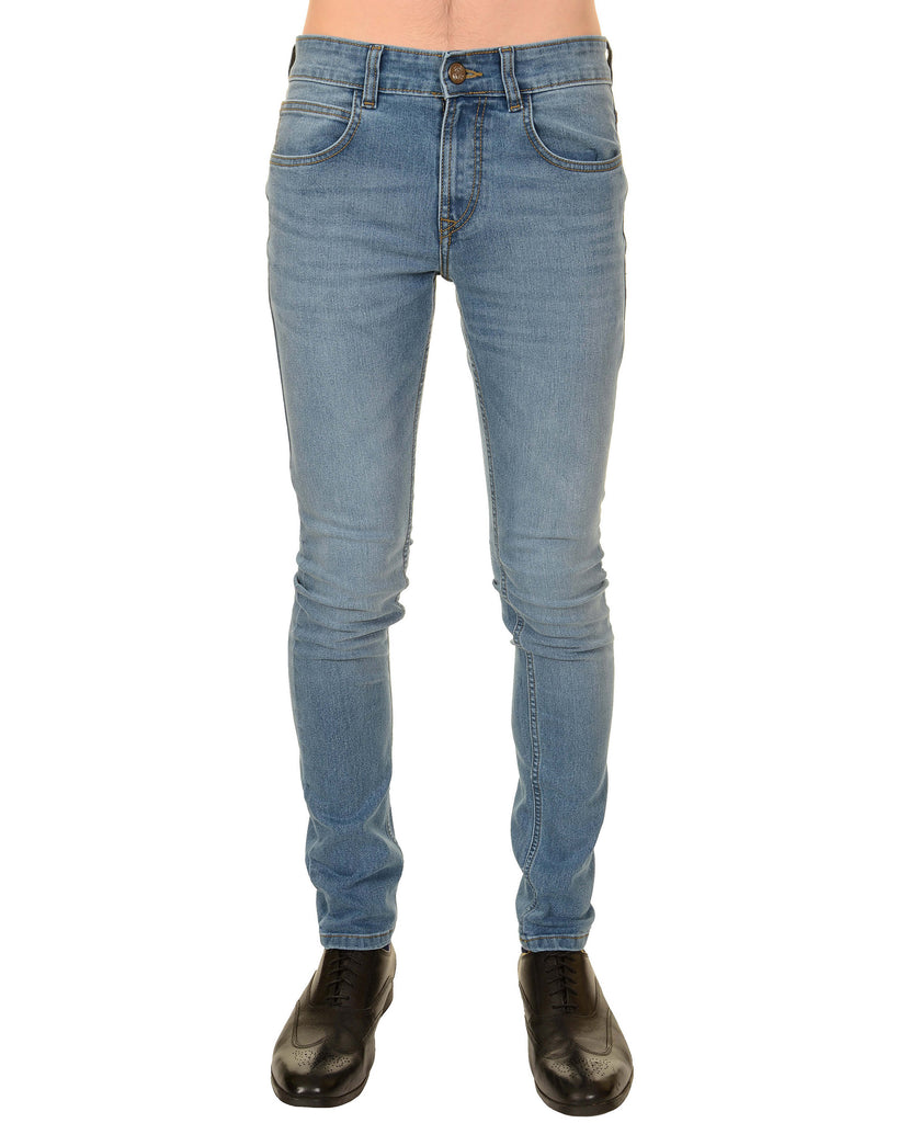 Model is stood in front of a white studio background wearing the distress denim skinny fit jeans with black brogue shoes. They are facing the camera and the photo is cropped from the waist down.