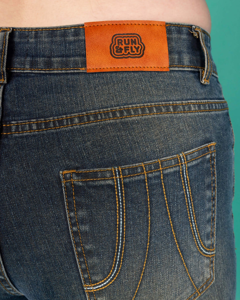 close up of the back of Unisex Distressed Denim Bellbottom Flares Mid Rise Jeans showing Run & Fly label and back pocket 