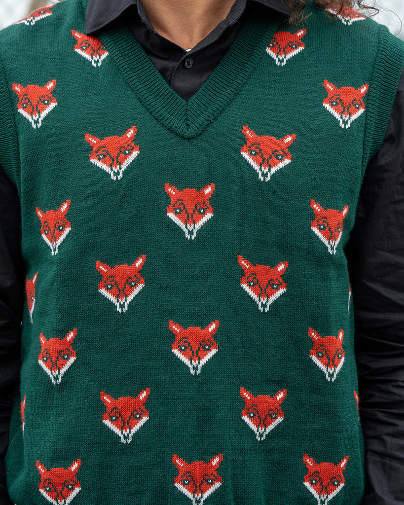 Close-up of the Run & Fly Fox Head Tank Vest showing detailed red fox head knit pattern on green fabric. Soft acrylic unisex design.
