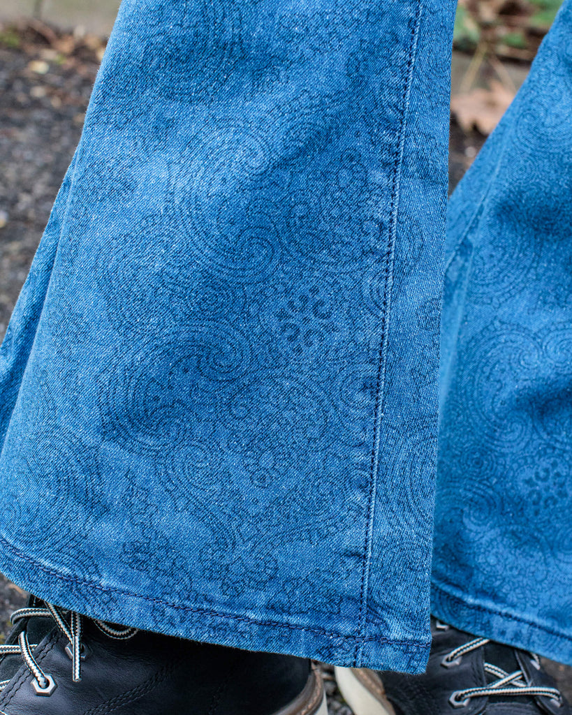 Close up shot of the flared bottoms on the retro stretch stone wash denim Hendrix paisley bell bottom flares.