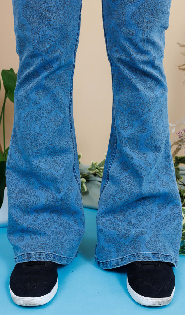 close up of Dec wearing New Fit Retro Stretch Stone Wash Denim Hendrix Paisley Bell Bottom Flares. Close up shows the flared bottoms of the jeans.