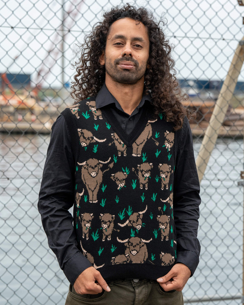 Front view of the unisex Run & Fly Highland Cow Tank Vest featuring an all-over brown highland cow print with green grass details, designed by Jen James Design. Made in England.
