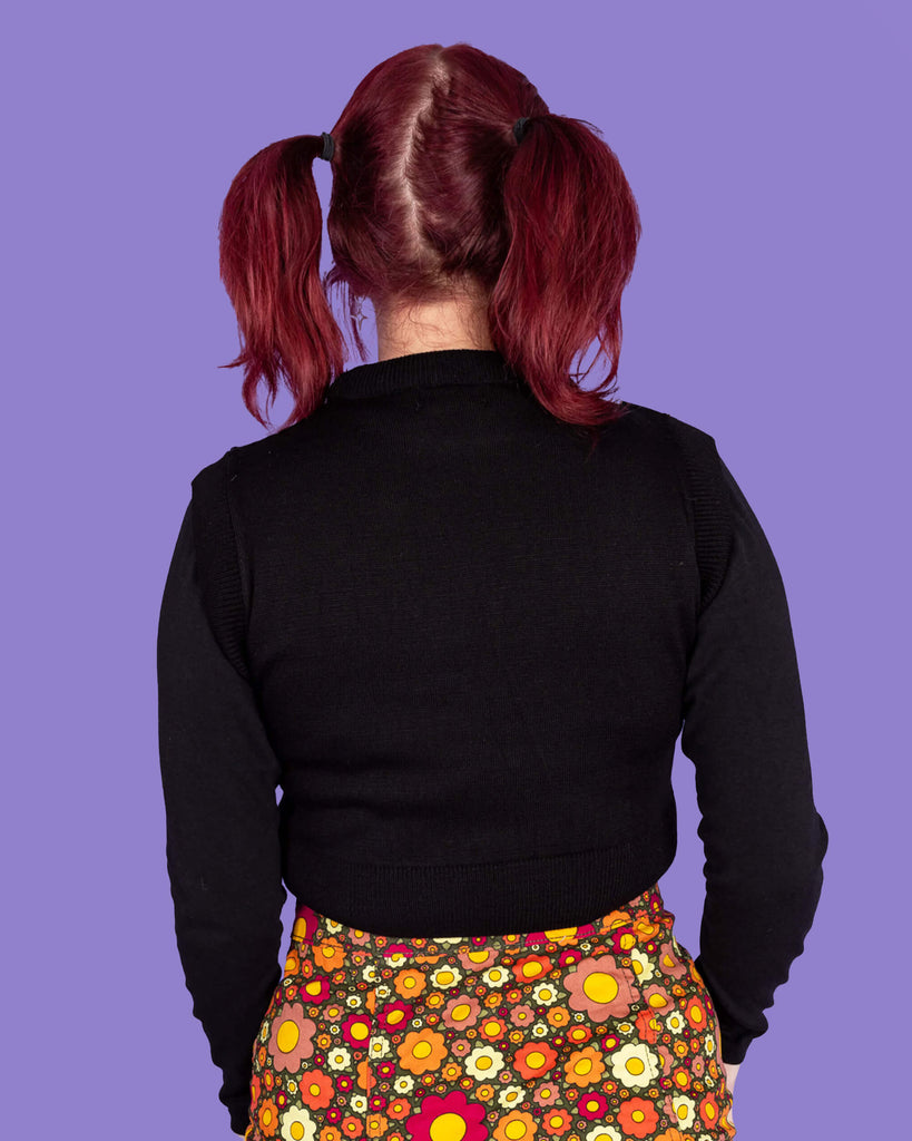 Close up of model wearing Owl Cropped tank. It has cute barn owls flying with yellow stars on a black background close up of the plain back