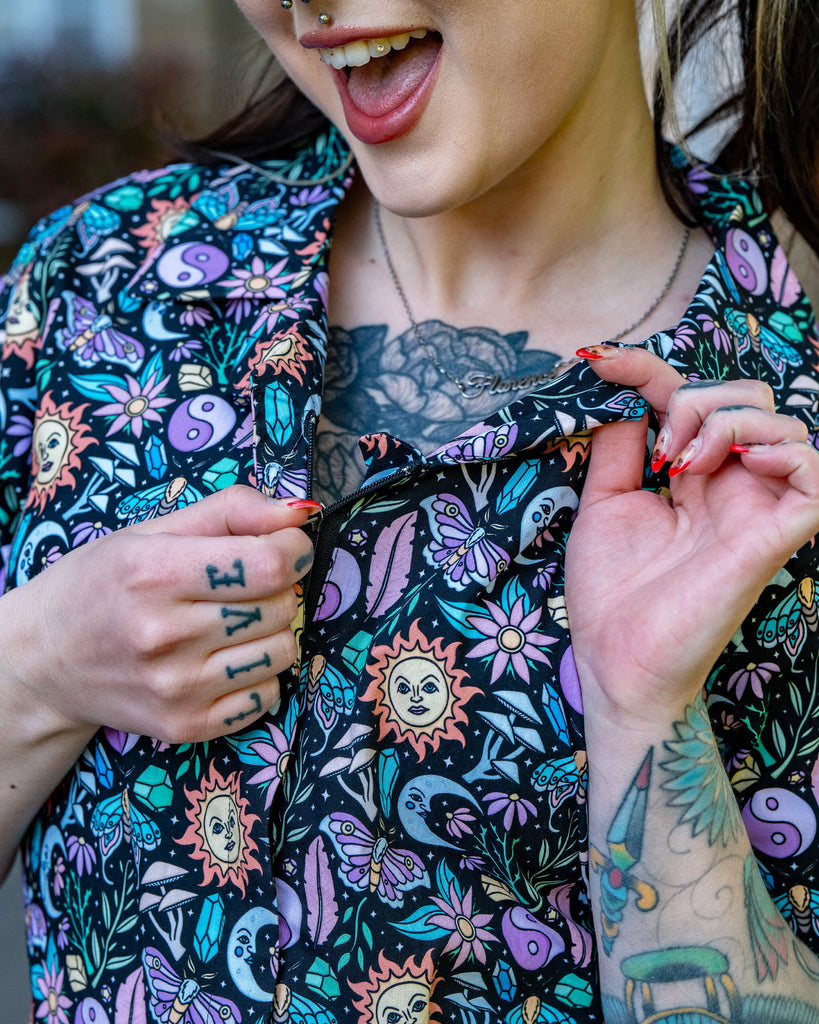 Model zips up the front of the Boho Summer Stretch Jumpsuit by Run & Fly, highlighting its comfy fit and whimsical celestial design. Created using Oeko-Tex approved dyes.