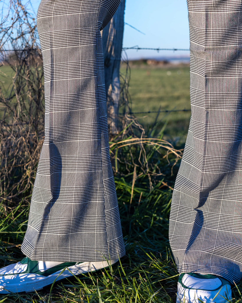 close up of the flared bottoms of the Presley Prince Of Wales Check Bell Bottom Trousers