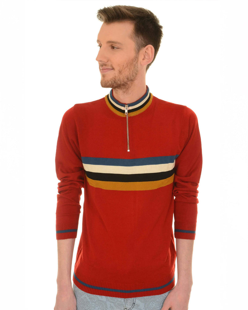 Model is wearing the Red Retro Zip Neck Jumper with light coloured jeans in front of a white wall