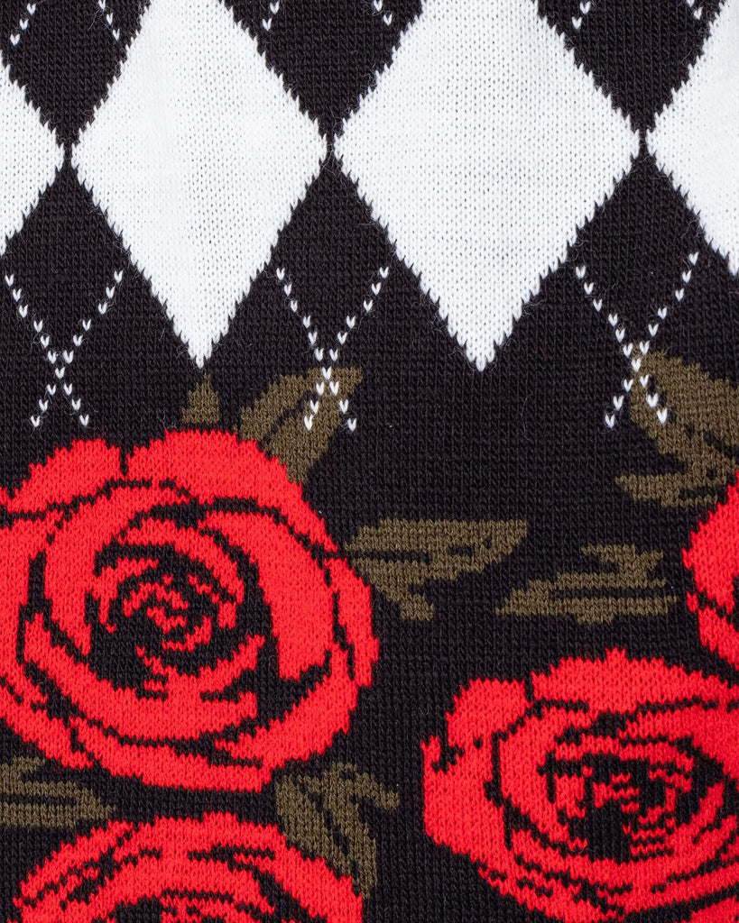Close up of the Rose and Argyle Knitted Tank Top. The black tank top has a black and white argyle print on the top half with a red rose pattern on the bottom half of the tank top.