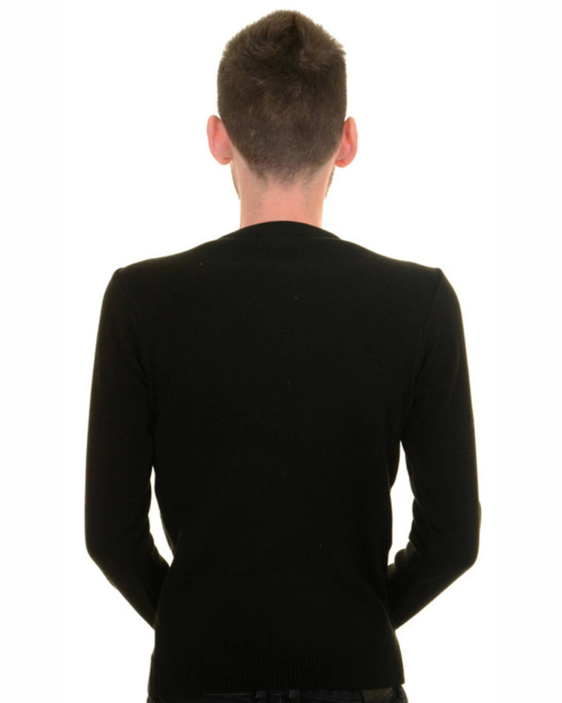 Back view of a model wearing the T Rex Dino-Roar Jumper with black trousers