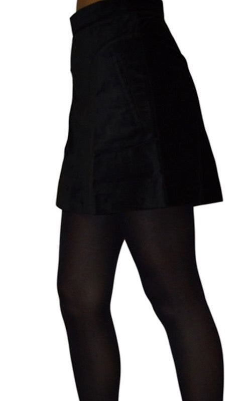 Photo has been cropped to show the hips and thighs. The model is wearing the Run and Fly a-line retro black velvet mini skirt with tights underneath. The model is facing to the left.