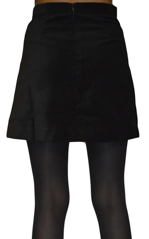 Photo has been cropped to show the hips and thighs. The model is wearing the Run and Fly a-line retro black velvet mini skirt with tights underneath. Model is facing away from the camera showing the zip on the back of the skirt.