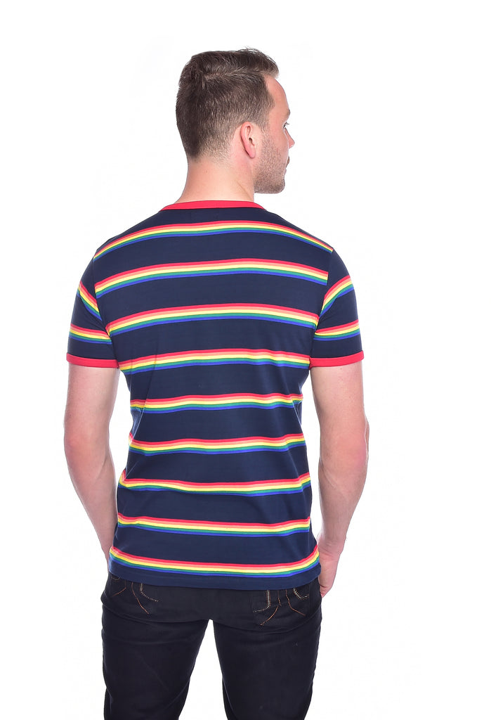 Model in front of a white background wearing the retro rainbow block striped tee . They are facing away from the camera to show off the back of the product