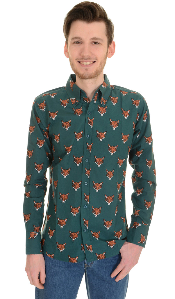 Model is stood in front of a white studio background wearing the fox print long sleeve shirt and blue denim jeans. They are facing the camera smiling and both hands resting on the front of their hips. Photo is cropped from the thighs up.