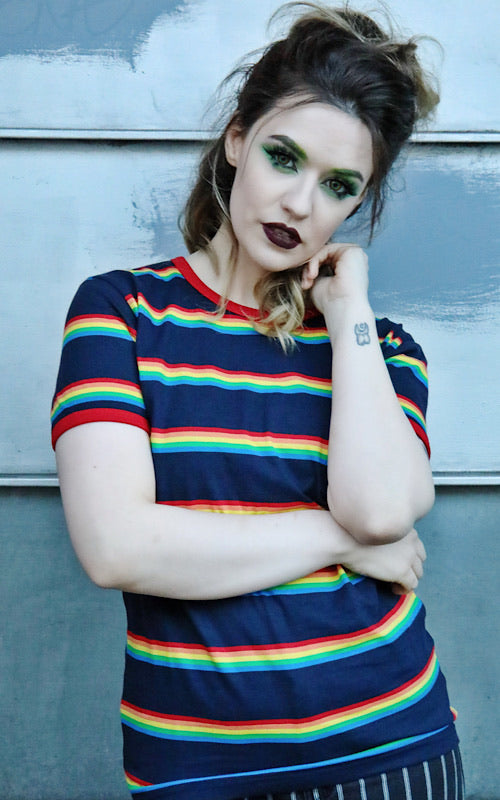Alice with her hair up and dark gothic makeup wearing the Retro Rainbow Block Striped T Shirt